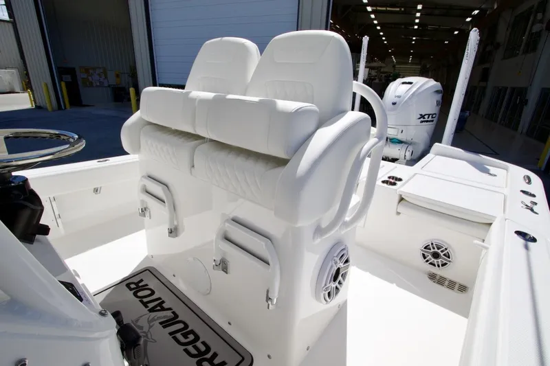 Slide: The Image of 2026 Regulator 26XO boat interior with open storage compartments and Yamaha engine. - 21
