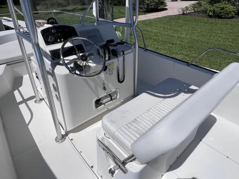 Slide: The Image of 2016 Boston Whaler 210 Montauk boat cockpit with steering wheel and seating. - 11