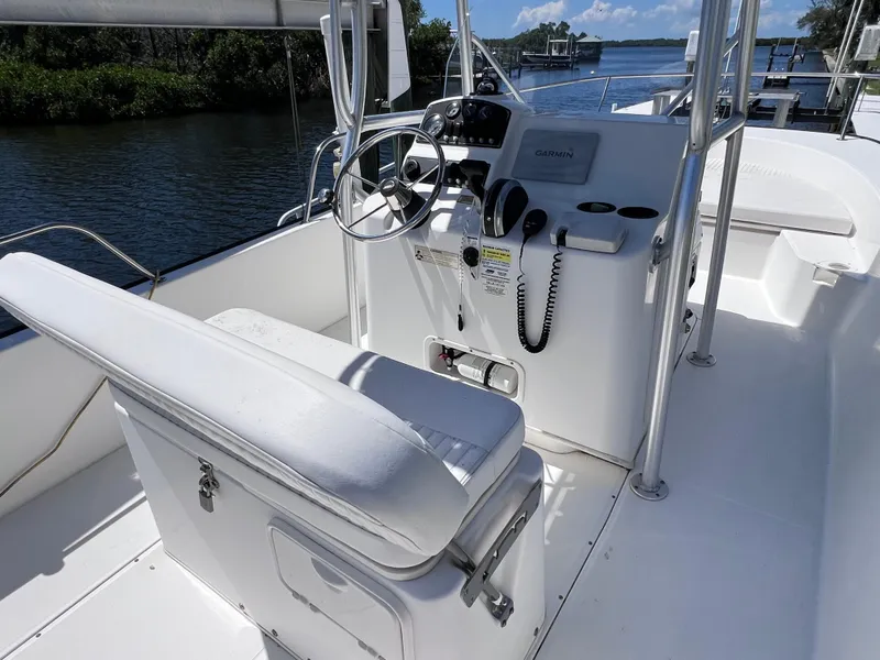 Slide: The Image of 2016 Boston Whaler 210 Montauk boat interior with steering console and seating. - 12