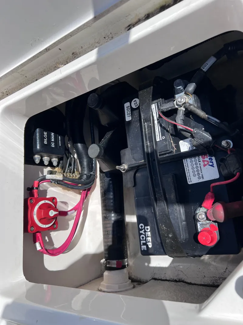 Slide: The Image of Battery compartment of a 2016 Boston Whaler 210 Montauk boat, featuring wiring and switches. - 19