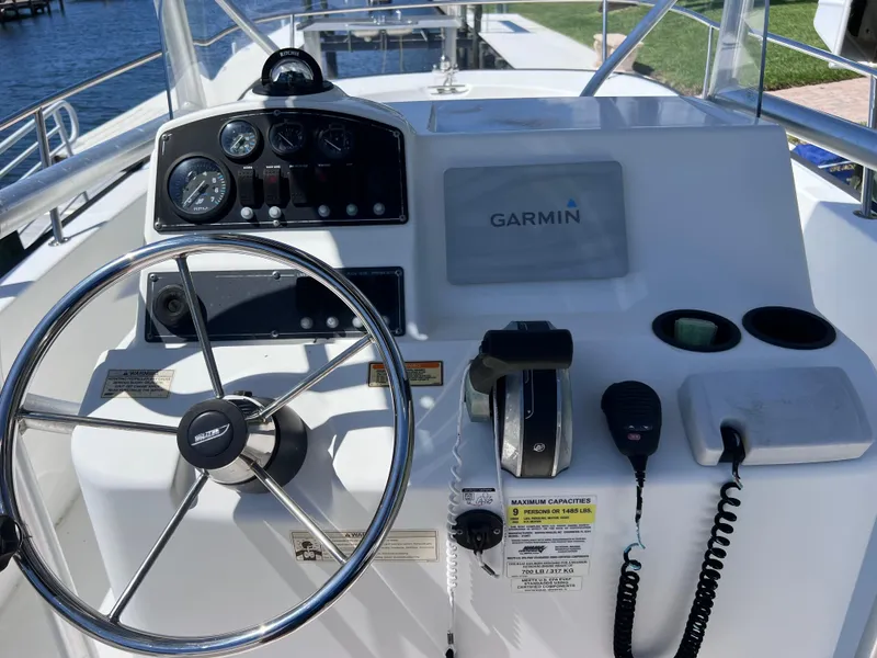 Slide: The Image of 2016 Boston Whaler 210 Montauk helm with Garmin navigation and steering wheel. - 20