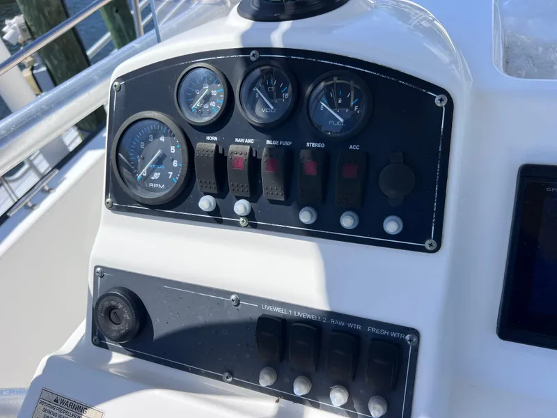 Slide: The Image of Control panel of a 2016 Boston Whaler 210 Montauk boat with gauges and switches. - 23