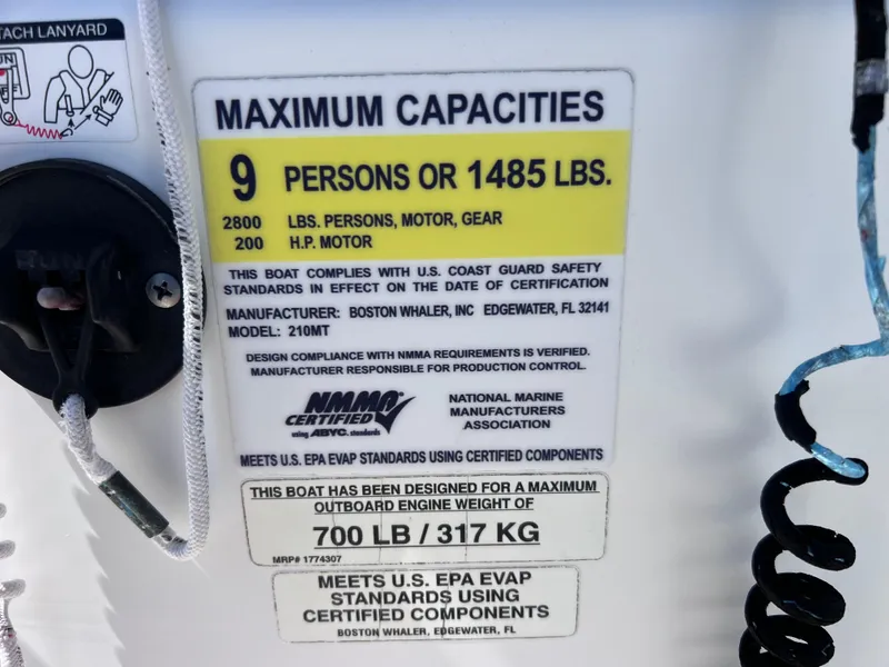 Slide: The Image of 2016 Boston Whaler 210 Montauk capacity label, maximum 9 persons or 1485 lbs, NMMA certified. - 26