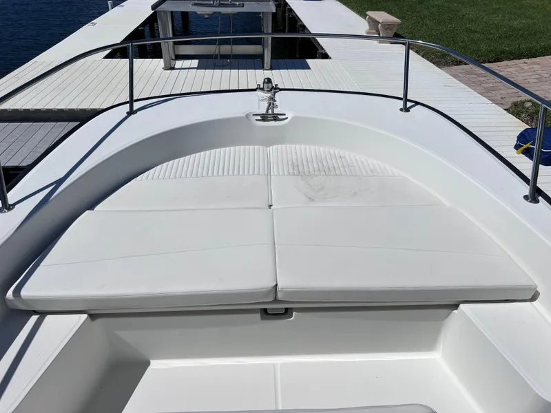 Slide: The Image of 2016 Boston Whaler 210 Montauk boat with cushioned seating at dock. - 28