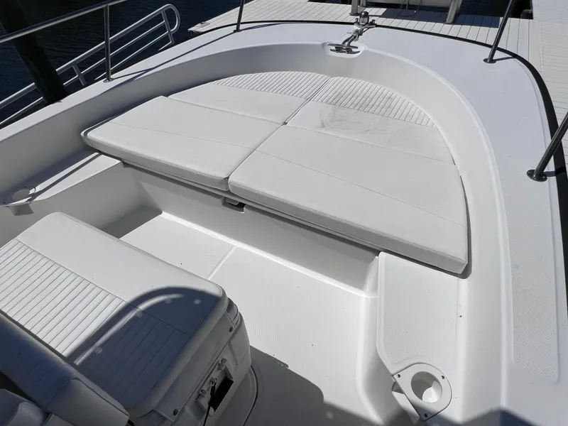 Slide: The Image of 2016 Boston Whaler 210 Montauk boat interior with white cushioned seating. - 29