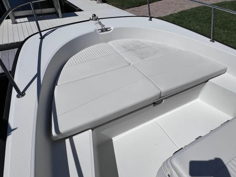 Slide: The Image of 2016 Boston Whaler 210 Montauk boat interior with cushioned seating and stainless steel railings. - 30