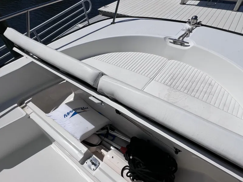 Slide: The Image of 2016 Boston Whaler 210 Montauk boat deck with storage compartment and MarineMax cushion. - 32