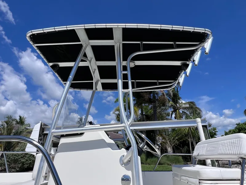 Slide: The Image of 2016 Boston Whaler 210 Montauk boat with T-top against a clear blue sky. - 8