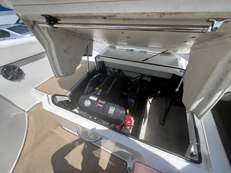 Slide: The Image of Open engine compartment of a 2013 Cobalt 24SD boat, showcasing the engine details. - 14