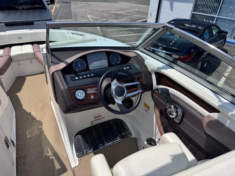 Slide: The Image of 2013 Cobalt 24SD boat interior with steering wheel and dashboard, featuring Garmin navigation. - 17