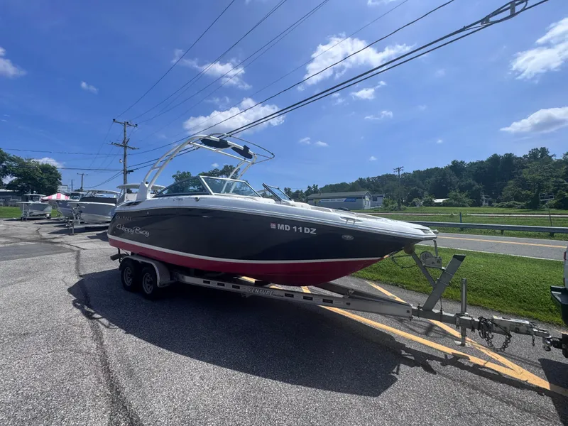 Slide: The Image of 2013 Cobalt 24SD boat on trailer under clear blue sky. - 4