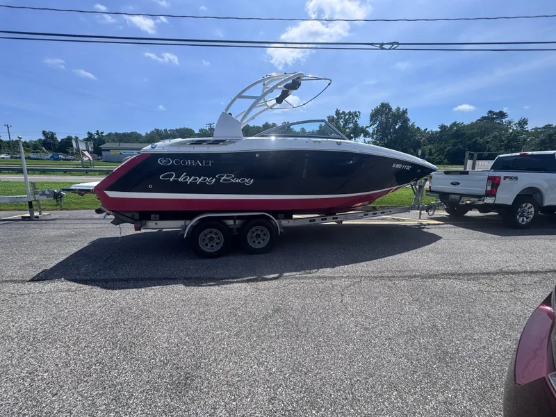 Slide: The Image of 2013 Cobalt 24SD boat named "Happy Buoy" on trailer, sunny day. - 5
