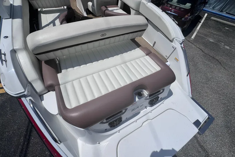 Slide: The Image of 2013 Cobalt 24SD boat interior with white and brown seating, rear view. - 9