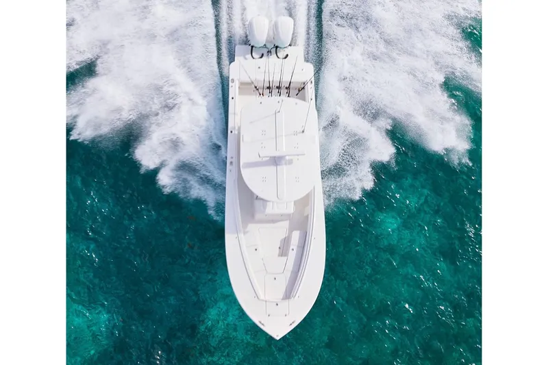 Slide: The Image of 2026 Regulator 28 boat interior with rod holders and Yeti cooler. - 13