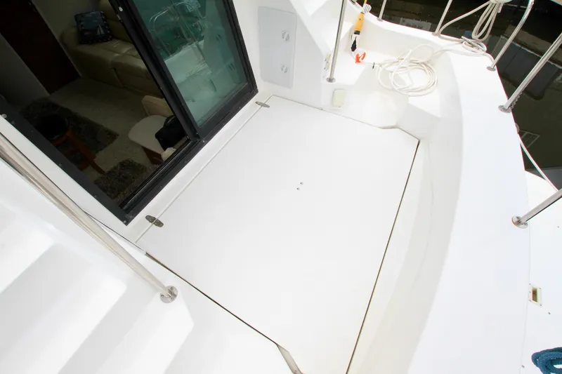 Slide: The Image of 2006 Harbor Master Coastal 400 boat deck with sliding glass door and railing. - 10