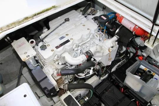Slide: The Image of Engine compartment of a 2006 Harbor Master Coastal 400 boat, featuring a well-maintained engine. - 17