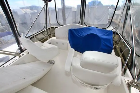 Slide: The Image of 2006 Harbor Master Coastal 400 boat interior with white seating and blue cover. - 20