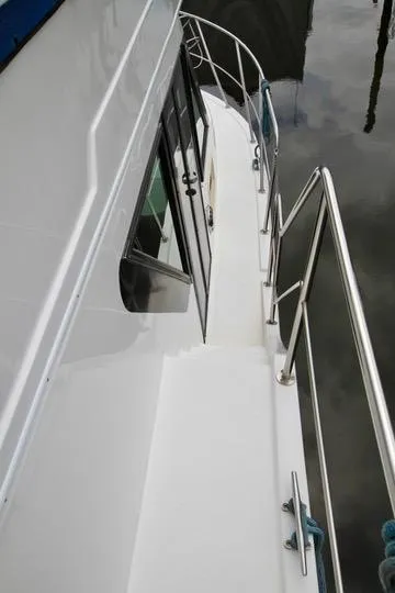 Slide: The Image of 2006 Harbor Master Coastal 400 boat deck with railing and water reflection. - 25