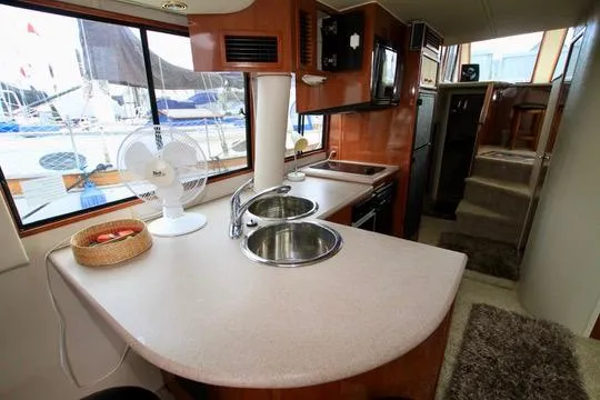 Slide: The Image of Interior of 2006 Harbor Master Coastal 400 yacht with kitchen and dining area. - 35
