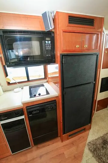 Slide: The Image of Compact kitchen in 2006 Harbor Master Coastal 400 with microwave, fridge, and dishwasher. - 41