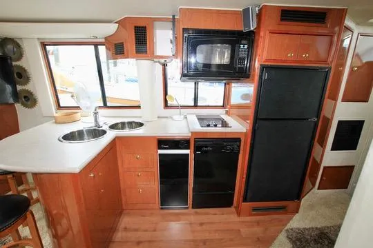 Slide: The Image of 2006 Harbor Master Coastal 400 kitchen with wood cabinetry, dual sinks, and modern appliances. - 42