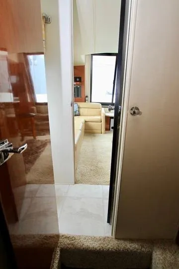 Slide: The Image of Interior view of 2006 Harbor Master Coastal 400 yacht, featuring a cozy living area. - 44