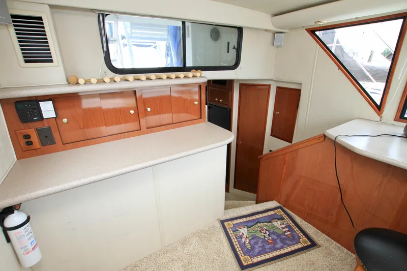 Slide: The Image of Interior of 2006 Harbor Master Coastal 400 yacht with wood cabinets and carpeted stairs. - 49