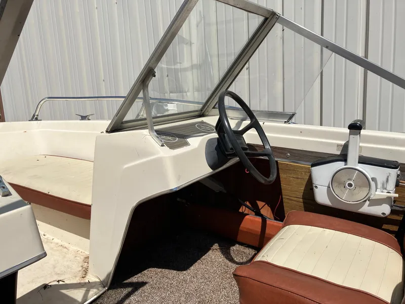 Slide: The Image of 1976 Glastron 156 Open Bow boat interior with steering wheel and seating. - 10