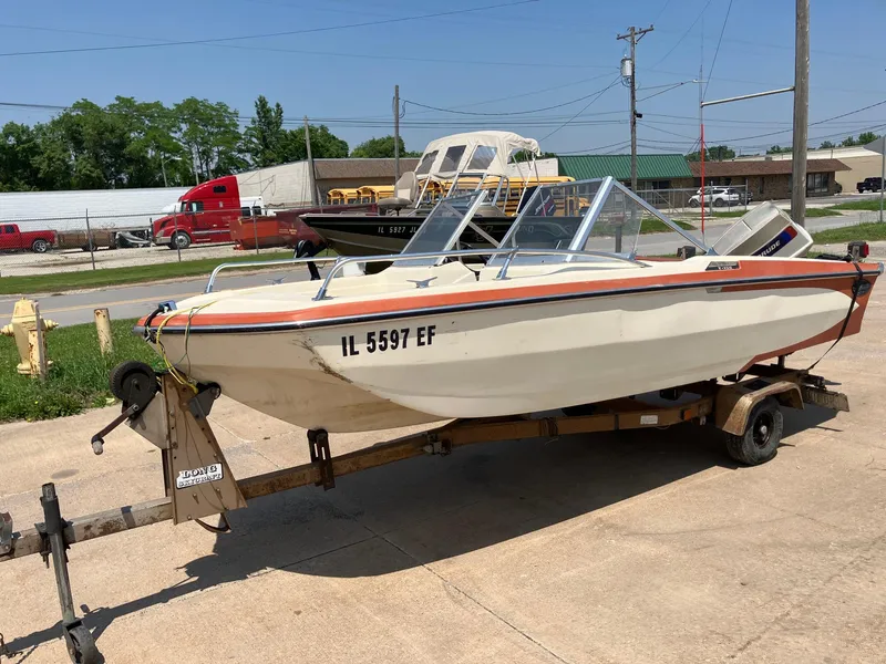 Slide: The Image of 1976 Glastron 156 Open Bow boat on trailer, parked outdoors. - 11