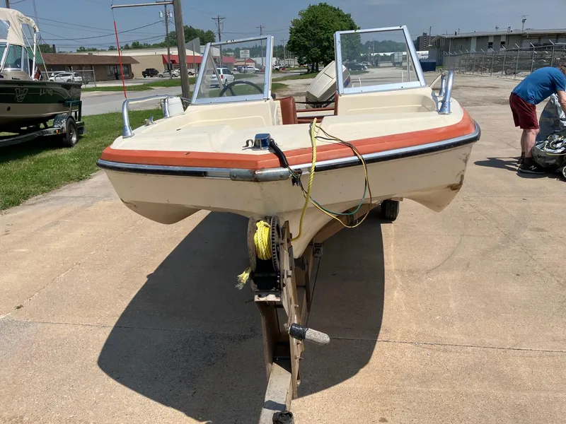 Slide: The Image of 1976 Glastron 156 Open Bow boat on trailer, parked outdoors on a sunny day. - 12