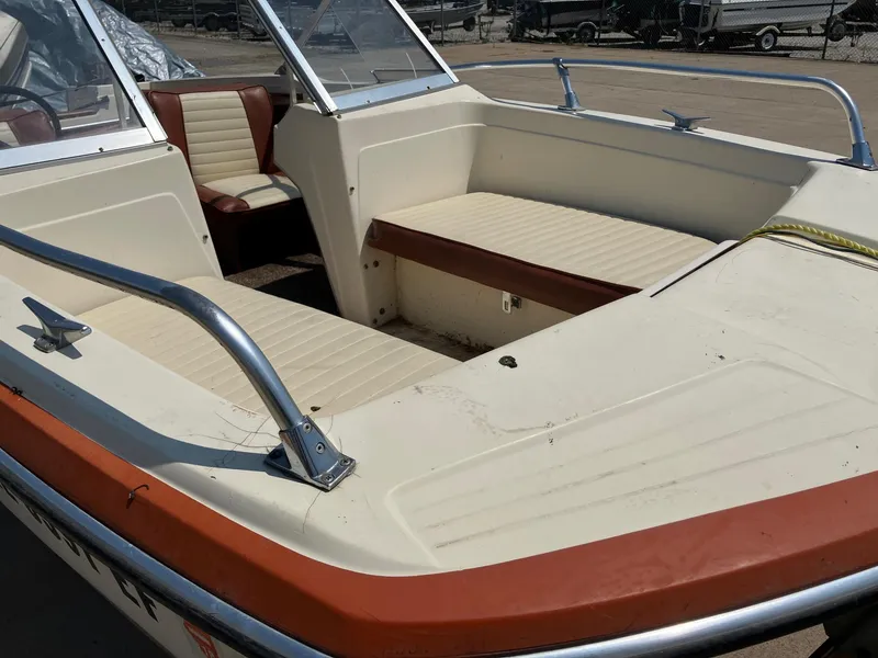 Slide: The Image of 1976 Glastron 156 Open Bow boat interior with beige and brown seating. - 15
