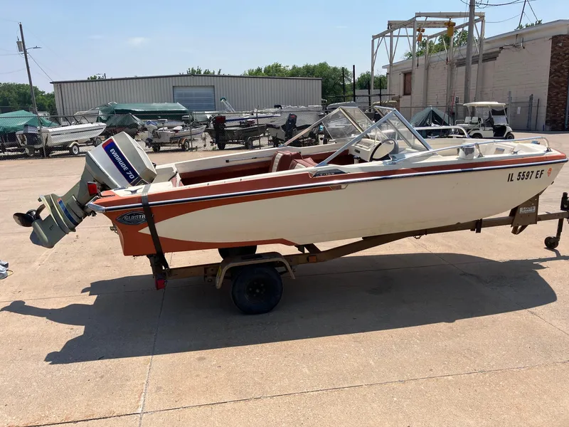Slide: The Image of 1976 Glastron 156 Open Bow boat on trailer, parked outdoors. - 16