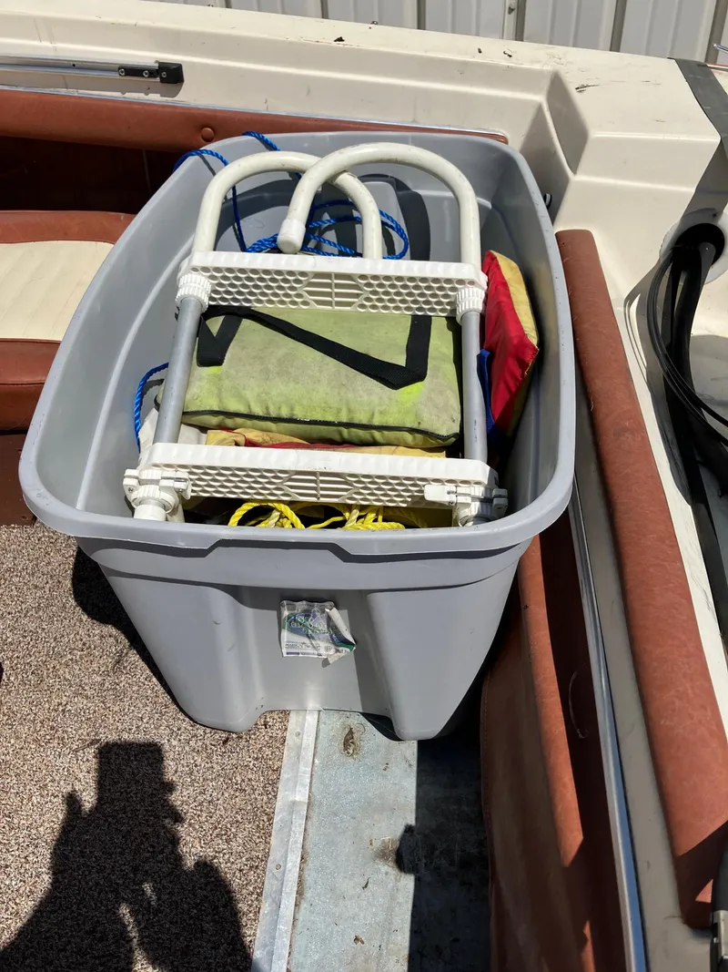 Slide: The Image of 1976 Glastron 156 Open Bow boat with storage bin containing ladder and ropes. - 18