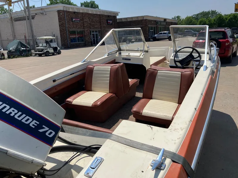 Slide: The Image of 1976 Glastron 156 Open Bow boat with Evinrude 70 engine, parked outdoors. - 19
