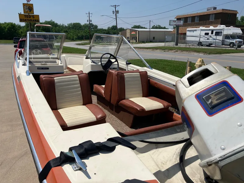 Slide: The Image of 1976 Glastron 156 Open Bow boat with vintage seating and outboard motor. - 22