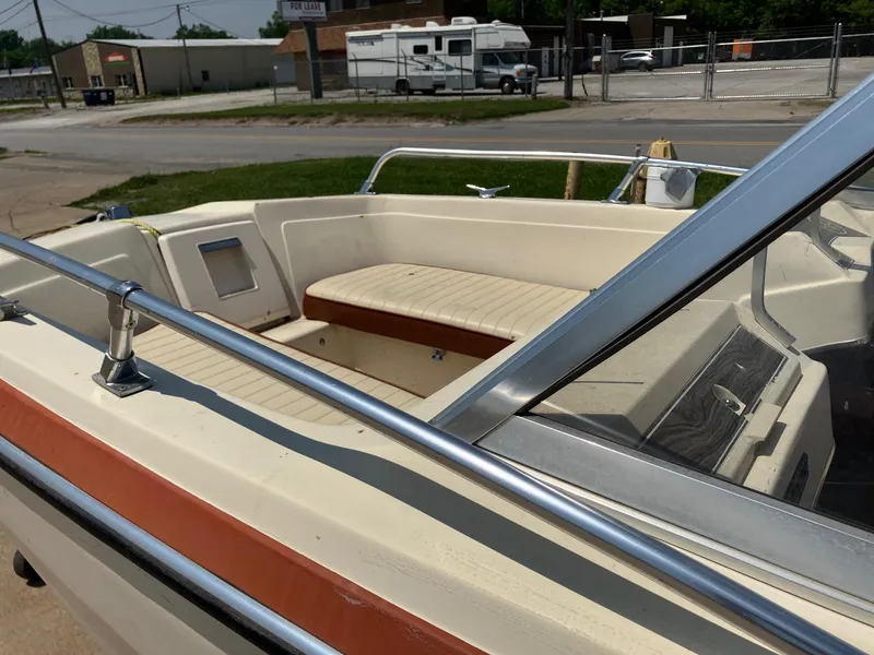 Slide: The Image of 1976 Glastron 156 Open Bow boat with beige seating and chrome railings. - 23