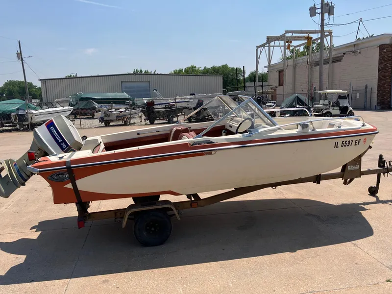 Slide: The Image of 1976 Glastron 156 Open Bow boat on trailer, parked outdoors. - 25