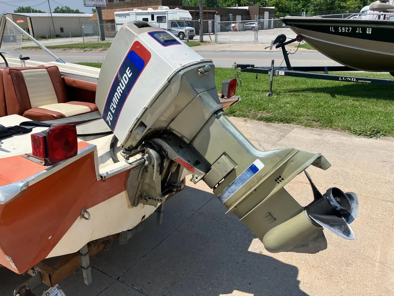 Slide: The Image of 1976 Glastron 156 Open Bow boat with Evinrude 70 outboard motor, parked on pavement. - 26