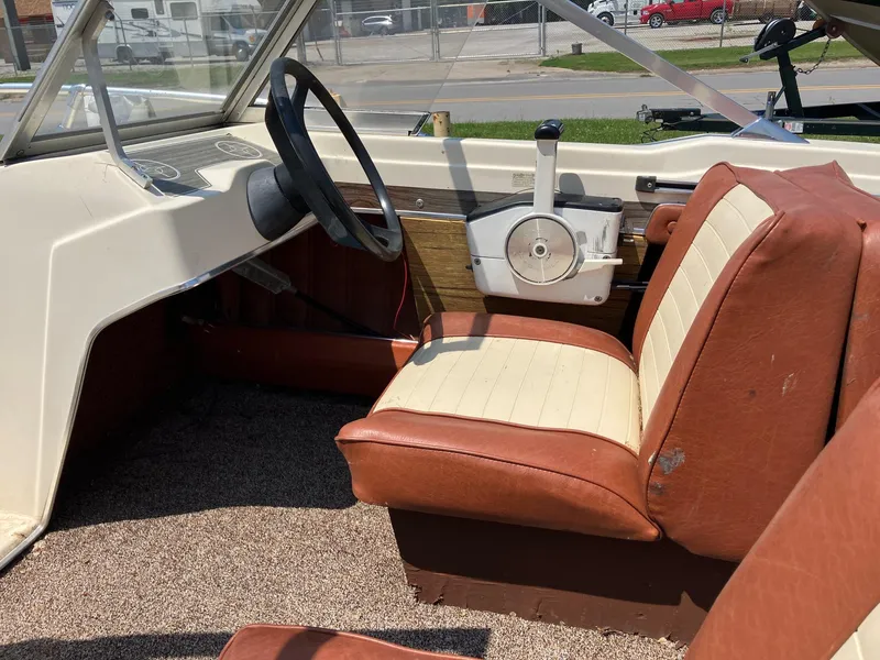 Slide: The Image of 1976 Glastron 156 Open Bow boat interior with vintage steering and seating. - 28