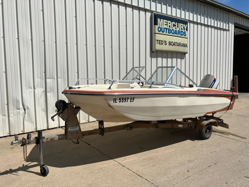 Slide: The Image of 1976 Glastron 156 Open Bow boat on trailer outside Mercury Outboards shop. - 30