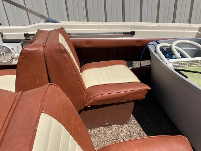 Slide: The Image of 1976 Glastron 156 Open Bow boat interior with brown and cream seats. - 6