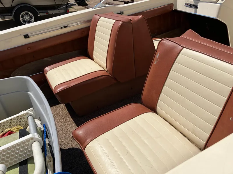 Slide: The Image of 1976 Glastron 156 Open Bow boat interior with brown and cream seats. - 7