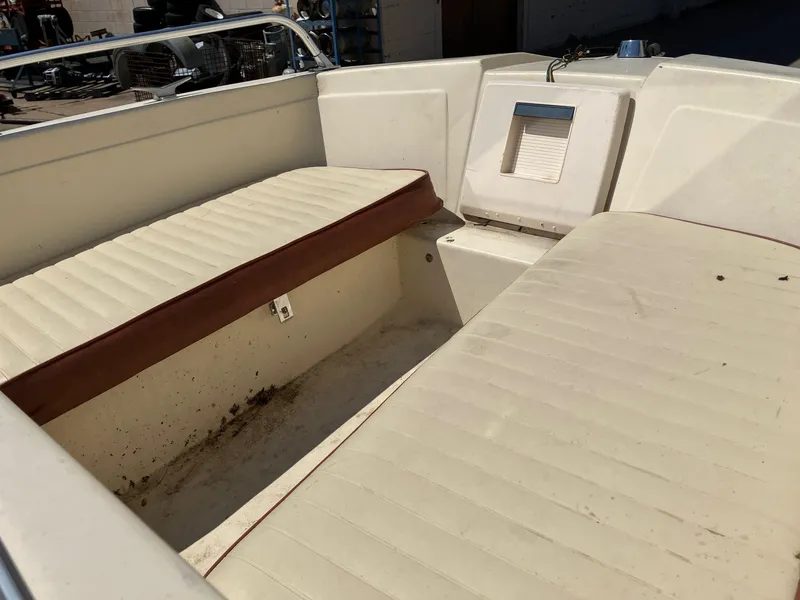 Slide: The Image of 1976 Glastron 156 Open Bow boat interior with beige seating and brown trim. - 9