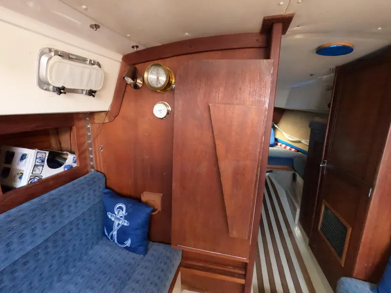 Slide: The Image of Interior of a 1984 CAL 31 sailboat with wooden paneling and nautical decor. - 15