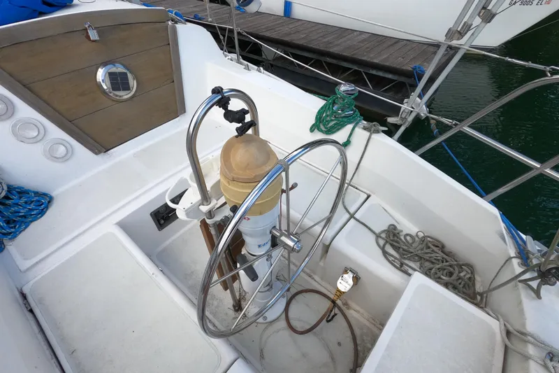 Slide: The Image of Cockpit of a 1984 CAL 31 sailboat with steering wheel and ropes. - 6