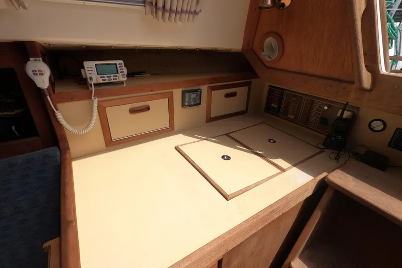 Slide: The Image of 1984 CAL 31 sailboat navigation station with communication equipment and storage compartments. - 9