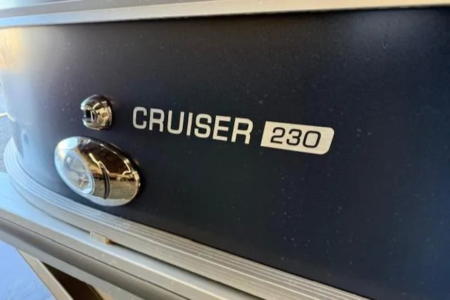 Slide: The Image of 2025 Harris Cruiser 230 CWDH boat emblem and logo detail. - 10
