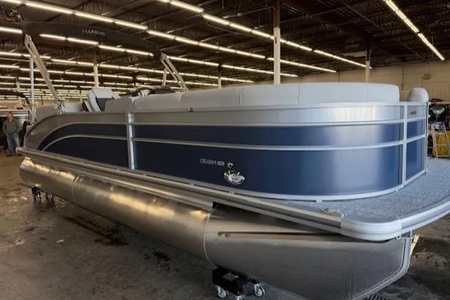 Slide: The Image of 2025 Harris Cruiser 230 CWDH pontoon boat in a warehouse setting. - 4