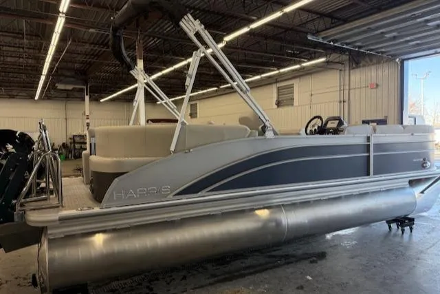 Slide: The Image of 2025 Harris Cruiser 230 CWDH pontoon boat in a warehouse setting. - 5