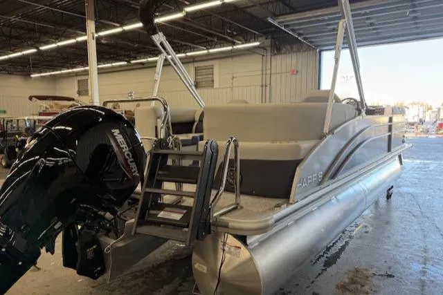 Slide: The Image of 2025 Harris Cruiser 230 CWDH pontoon boat in warehouse, featuring Mercury outboard motor. - 6